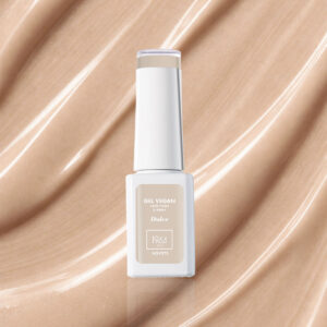 Bottle of Dulce NGV272 sandy nude vegan gel varnish on a textured luminous beige base.