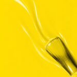 Liquid form of Zoé vegan semi-permanent nail varnish, yellow shade (ref. NGV173), 1944 Paris